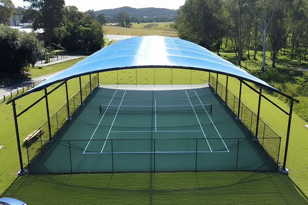Aerial view of a full tennis court under a blue curved tensile canopy on a black steel frame